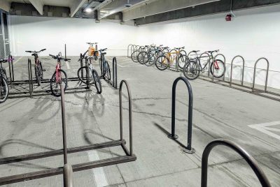 Secure bike storage in the Perry Street Parking Garage. Photo shows bicycles in racks inside of the garage.